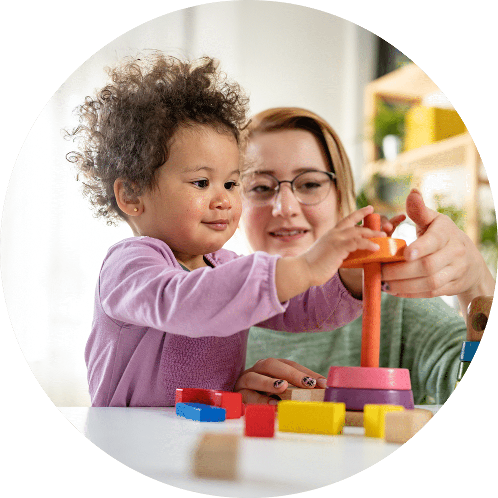 Mother and daughter happily playing with wooden toys